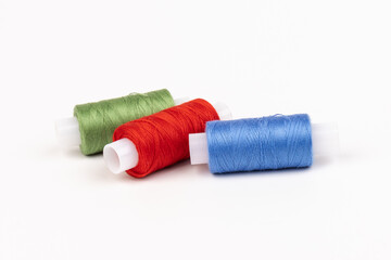 Color sewing threads isolated on white background. Different colors.Bright bobbin thread.