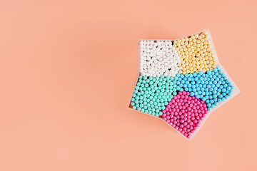 A box with colorful cotton swabs for cleaning ears. Hygiene concept