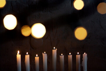 Nine burning candles in the dark. Hanukkah celebration.