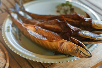 Fresh hot smoked mackerel on the table.
