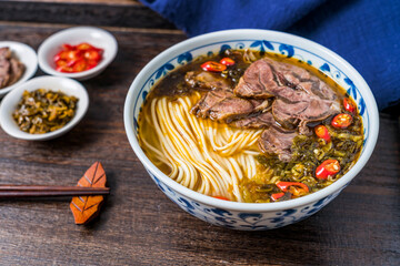 Beef noodles with sauerkraut in old altar on wooden table 