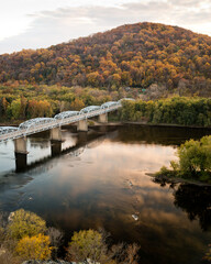 Point of Rocks Bridge spans the gorgeous Potomac River across from the state of Maryland to the state of Virginia on a sunny Autumn afternoon. - obrazy, fototapety, plakaty