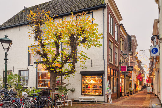 View at the ancient Dutch Fnidsen shopping street with christmas decoration in the city center of Alkmaar, The Netherlands on November 10, 2021