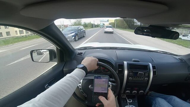 driving car and texting message on the phone
