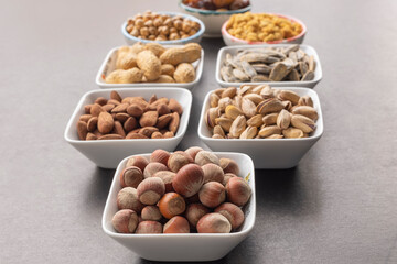 Nuts in selective focus. Dried mulberry, almond, pistachio, grape, pistachio and sunflower seeds in the background.