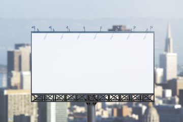 Obraz premium Blank white billboard on city buildings background at daytime, front view. Mockup, advertising concept