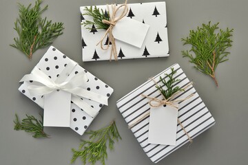 Christmas gift boxes with black and white pattern wrapping paper, gift tags mockup, Nordic style...