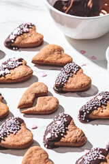Heart cookies glazed in chocolate and pink sprinkles on white background. Valentine day concept.
