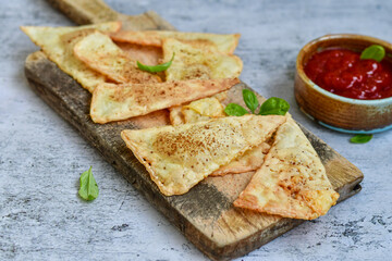  Home made ketogenic  Crispy nachos  tortilla chips with spicy red sauce. Mexican snack  for cinema.