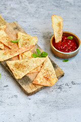  Home made ketogenic  Crispy nachos  tortilla chips with spicy red sauce. Mexican snack  for cinema.