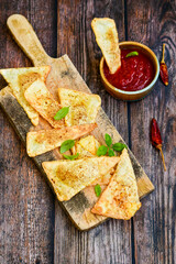  Home made ketogenic  Crispy nachos  tortilla chips with spicy red sauce. Mexican snack  for cinema.