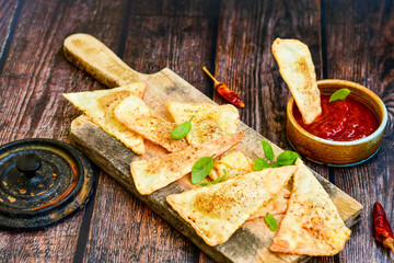  Home made ketogenic  Crispy nachos  tortilla chips with spicy red sauce. Mexican snack  for cinema.