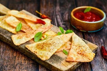  Home made ketogenic  Crispy nachos  tortilla chips with spicy red sauce. Mexican snack  for cinema.