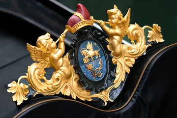 Deurstickers Gondels Gilt detail of gondola in Venice: badge with two winged putti with trumpets