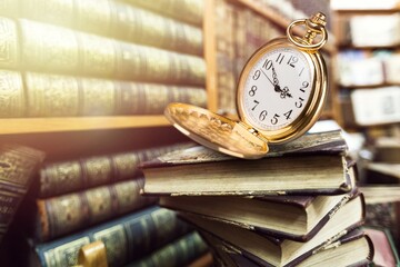 Vintage pocket watch and books. Vintage background Concept of time history.