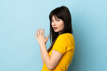 Teenager Ukrainian girl isolated on blue background scheming something