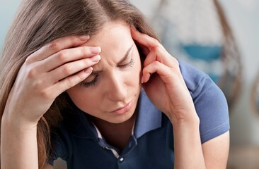 Distressed tired woman touch temples, suffer huge migraine need painkillers, painful headache,