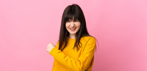 Young Ukrainian woman isolated on pink background celebrating a victory