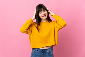 Young Ukrainian woman isolated on pink background laughing