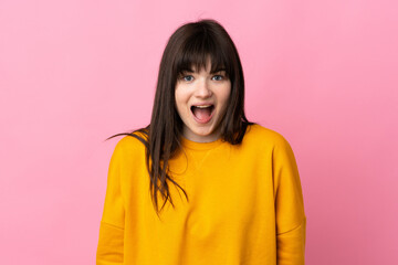 Fototapeta premium Young Ukrainian woman isolated on pink background with surprise facial expression
