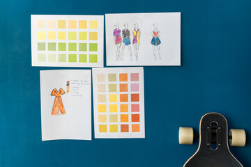 Color swatches and sketches hanging on a designer's wall at the studio. Cropped view of the...