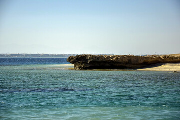 Scenic view of deserted seaside against backdrop of blue sky. Beautiful seascape. Copy space. Selective focus.