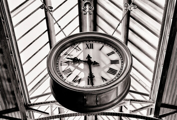 Black and white concept of an old public clock of the 19th century under a vaulted dome (St. Petersburg, Russia)