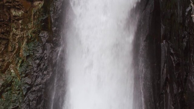 Close video footage of the waterfall camera moves from the bottom up.