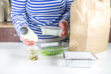 Caucasian woman take apart package with Heat-and-eat meal boxes from the restaurant. Takeout order delivery service food concept, close-up - obrazy, fototapety, plakaty