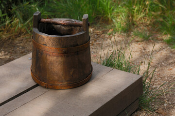 An old wooden bucket used to get water out of a well
