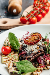 Beef steak barbecue sliced with salad grilled vegetables, nuts, sauce and parmesan. Italian cuisine concept. vertical image. top view