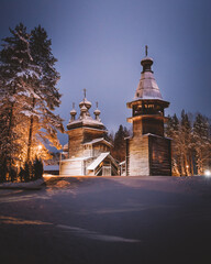 The Russian north old church in winter forest
