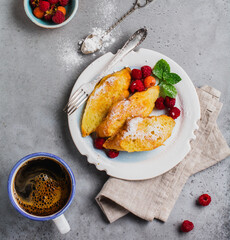 French sweet toasts with berries. Old gray vintage background. Top view. Copy space.