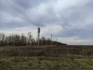 Agricultural field electric poles and water tower in winter