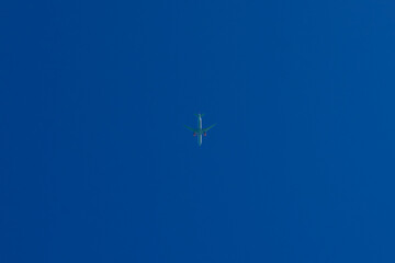 airliner high in the cloudless sky.
