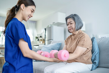 Obraz premium Asian Disabled old woman doing physiotherapist with support from nurse