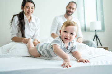 Obraz premium Portrait of Caucasian happy family smiling, look at camera in bedroom.