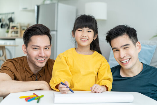 Asian attractive LGBTQ gay family teach young girl kid draw picture. 