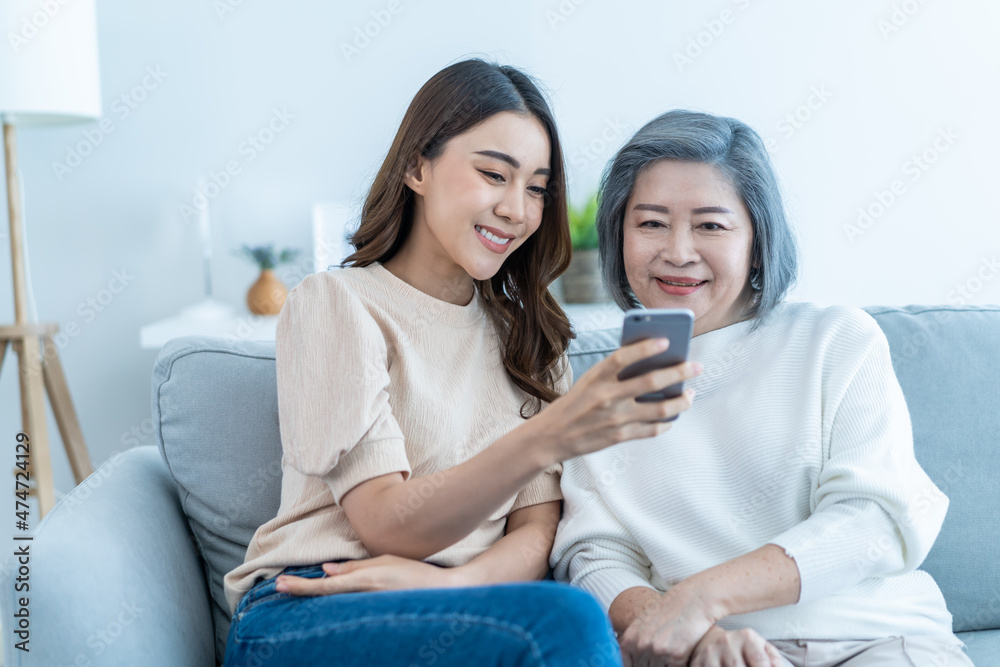 Wall mural asian lovely family, young daughter use phone selfie with older mother