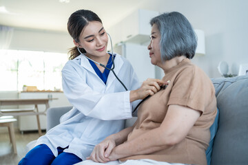 Asian nurse at nursing home take care of disabled senior elderly woman