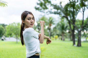 Asian young beautiful sport woman doing yoga workout outdoors in park. 