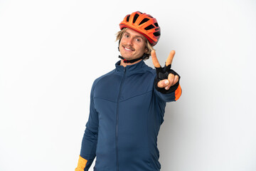 Young blonde cyclist man isolated on white background smiling and showing victory sign - obrazy, fototapety, plakaty