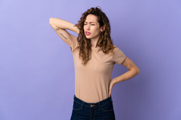 Fototapeta premium Young caucasian woman isolated on purple background with neckache
