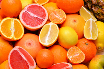 colorful background different citrus fruits, lemons, tangerines, oranges, grapefruits