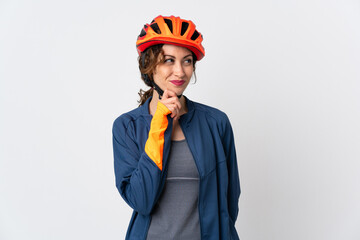 Young cyclist woman isolated on white background and looking up