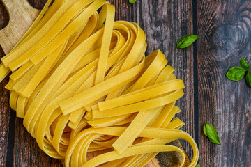 Raw fresh  uncooked tagliatelle egg pasta . Ready for cooking. Italian food concept. Kitchen poster