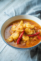 Shrimps curry with chilli in a white plate