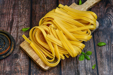 Raw fresh  uncooked tagliatelle egg pasta . Ready for cooking. Italian food concept. Kitchen poster