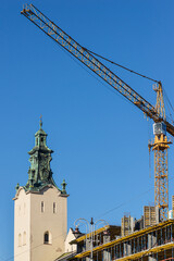 Fototapeta na wymiar LVIV, UKRAINE - November, 2021: The tower of The Archcathedral Basilica of the Assumption of the Blessed Virgin Mary or the Latin Cathedral. Сonstruction crane.