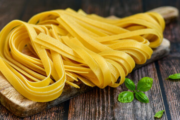 Raw fresh  uncooked tagliatelle egg pasta . Ready for cooking. Italian food concept. Kitchen poster